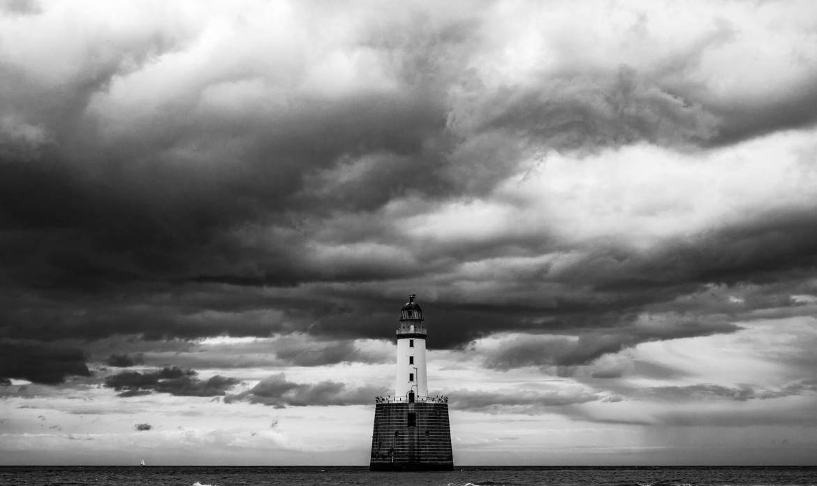 Lighthouse with a grey skyline behind it, to show how Zero Trust helps keep a watchful eye over those working in your organisational waters.